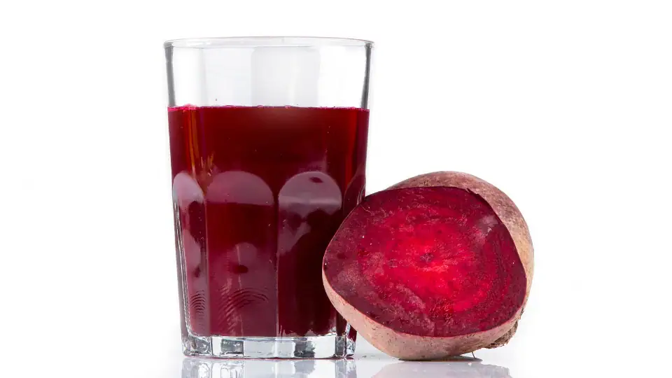 A glass of beetroot juice on a kitchen table