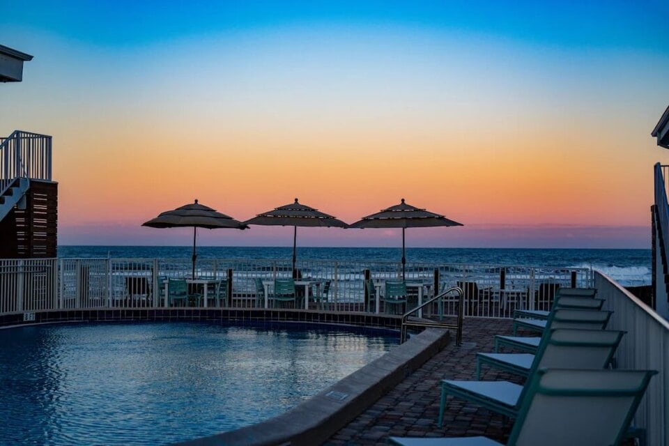 Image of sunset and pool view overlooking the ocean at a favorite of the Melbourne Beach Florida hotels
