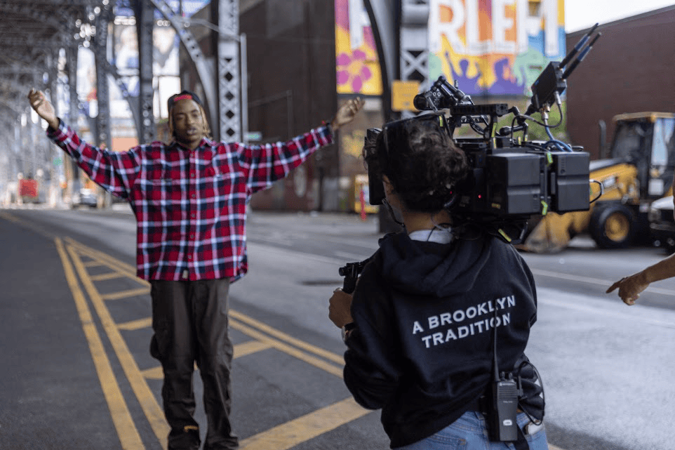 An image of a camerawoman filming a guy for a short video