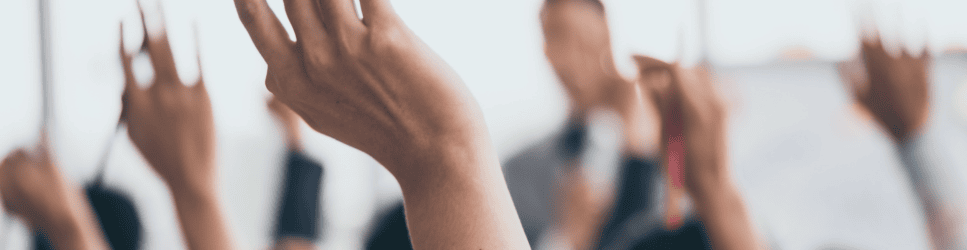 Image of hands up voting for article header
