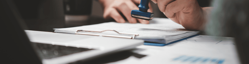 Image of documents being stamped for Immigration act header image