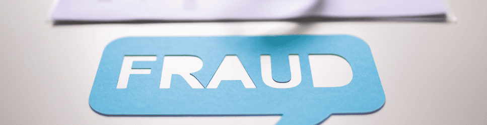 Speech bubble saying Fraud with some corporate papers in the background