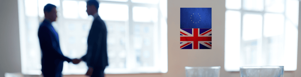 Image of negotiations wih European flag and United Kingdom flag on the wall.
