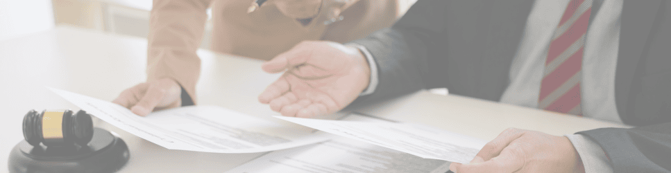 Court of Protection Applications Header image of a solicitor reviewing documents with a client