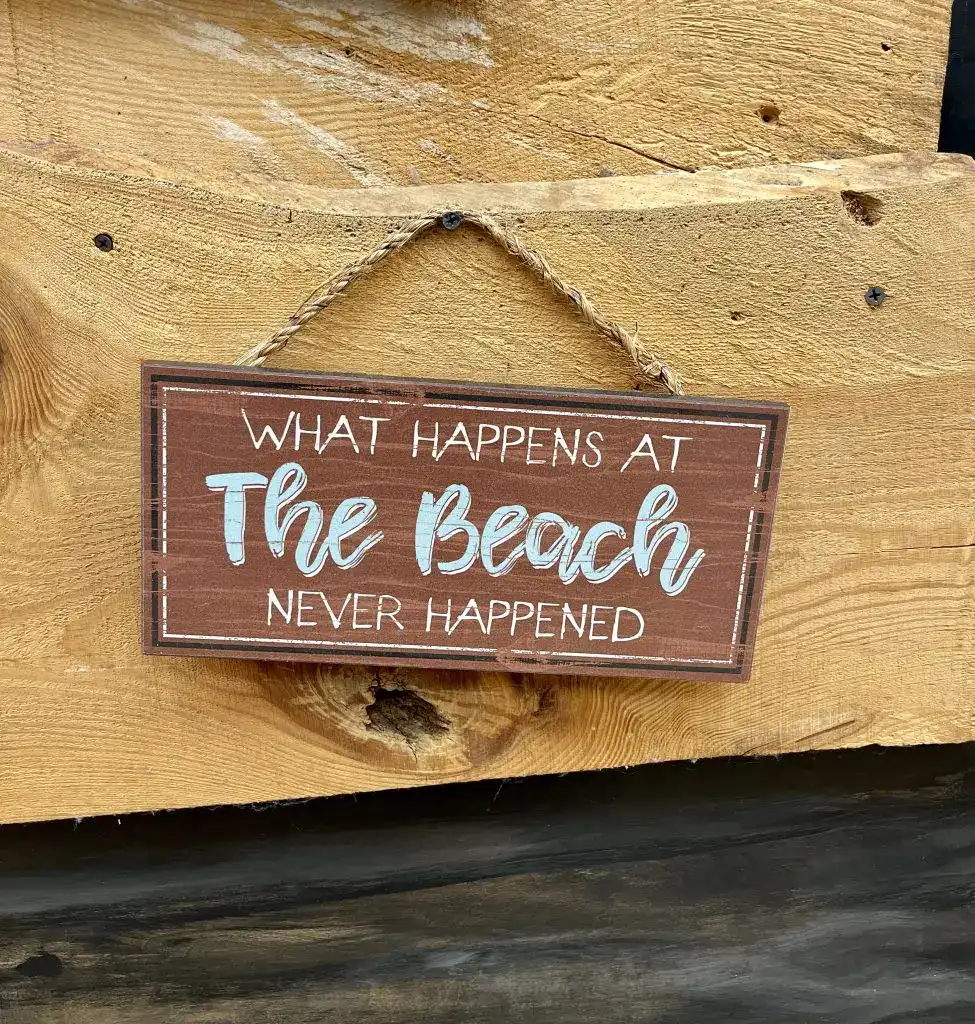 What happens at the beach never happened sign