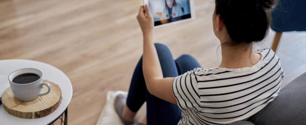 Young woman having a video conference with her doctor Young woman having a video conference with her doctor