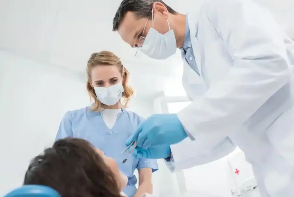 Dental team reviewing patient records for tooth extractions in Riverview, MI at a modern clinic