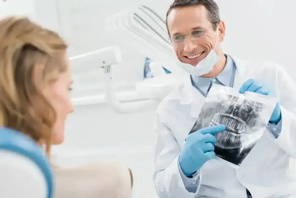 Dentist explaining dental X ray results before tooth extrctions in Riverview, MI.