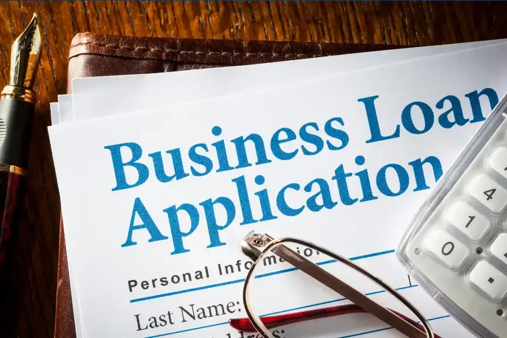 Entrepreneurs discussing top small business loan options in a meeting