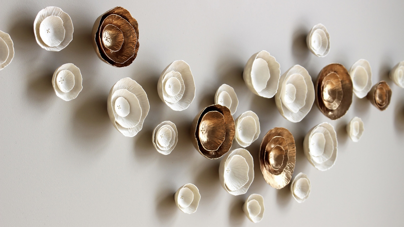 Porcelain 3D wall flower grid with a gold accent, handmade wall art for interior design.