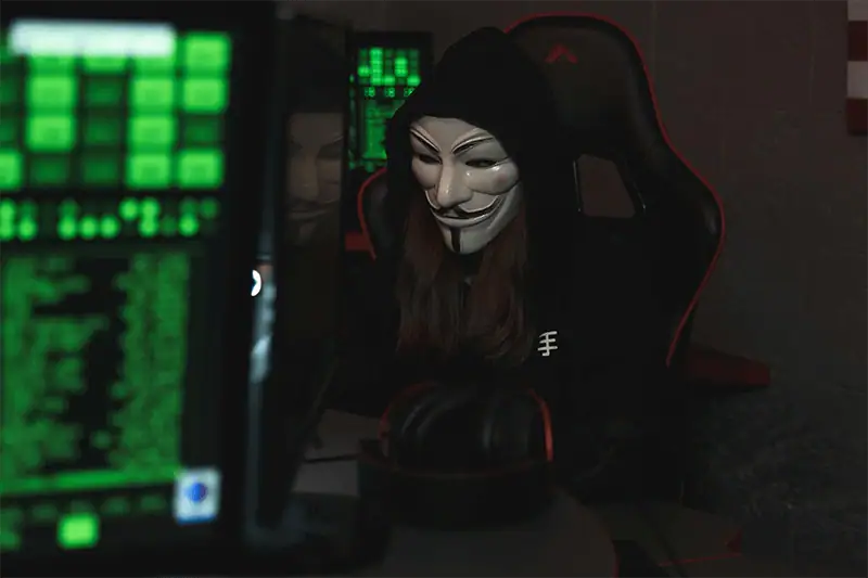 A hacker in front of servers