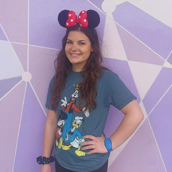 Minnie Mouse ears headband with red polka dots, Disney-themed casual outfit, fun Disney-inspired look for vacation.