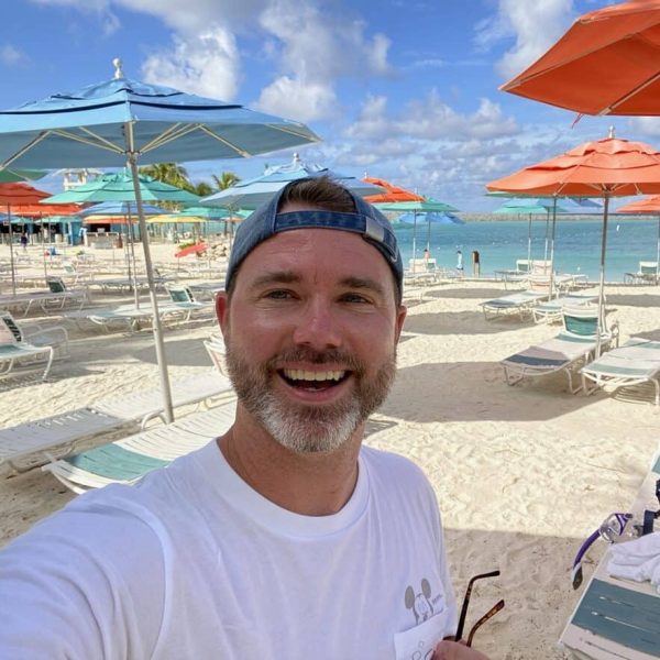 Relaxing beach vacation with colorful umbrellas and sunny weather at 407 and Beyond Vacation Co.