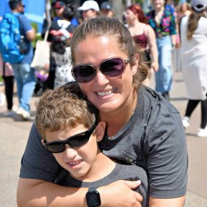 Family enjoying vacation at outdoor event with sunny weather.