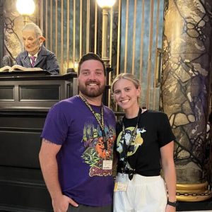 Smiling couple at 407 and Beyond Vacation Co. event, vibrant atmosphere, and elegant decor, showcasing exceptional vacation planning and travel services.