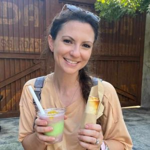 Refreshing tropical drink and snack at 407 and Beyond Vacation Co. outdoor dining, enjoying Florida vacation vibes.