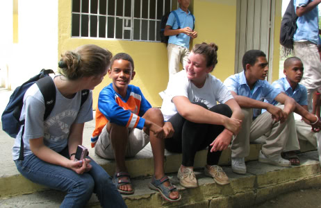 ACIS participants sit with local school children in the Dominican Republic