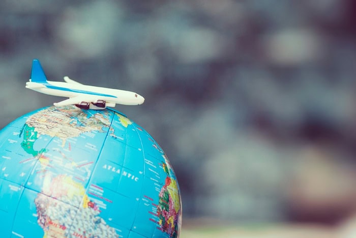 small airplane model on top of a globe