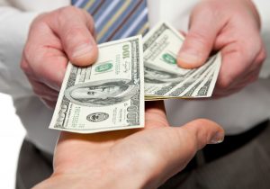 Hands Handing Over Us Dollar Bills