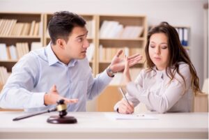 Couple Arguing Over Legal Documents With A Gavel