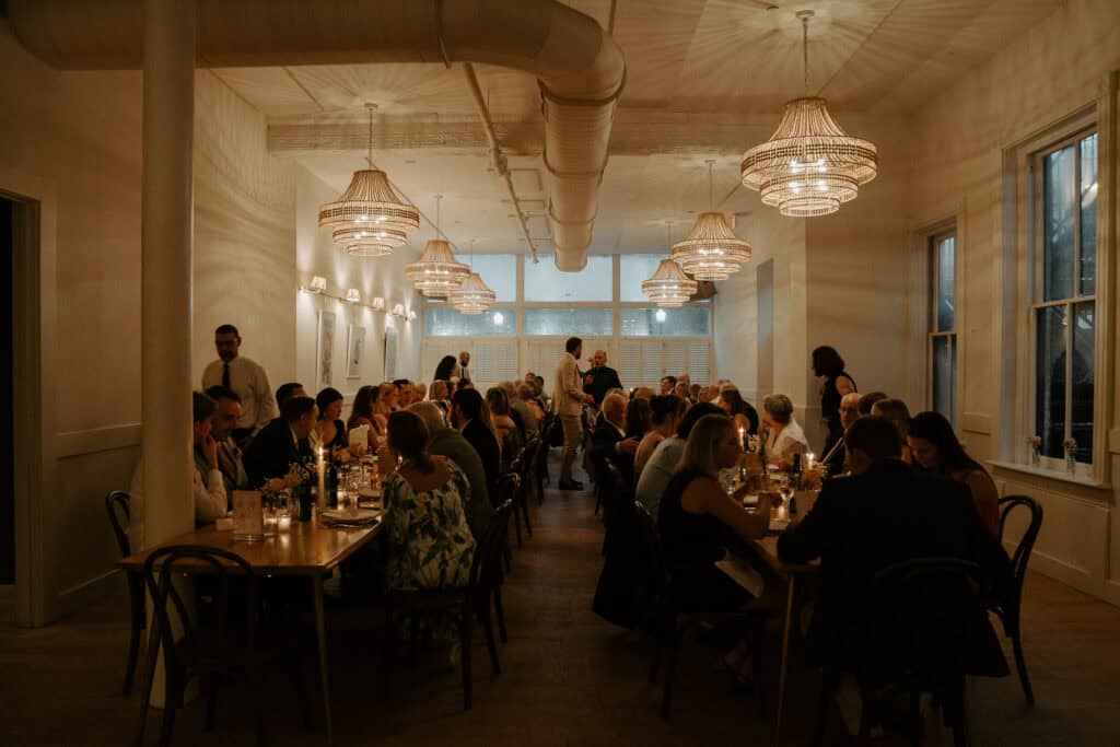 Elegant wedding reception dinner in Charlottesville with romantic candlelight ambiance, featuring long tables decorated with glowing candles and intimate atmosphere.