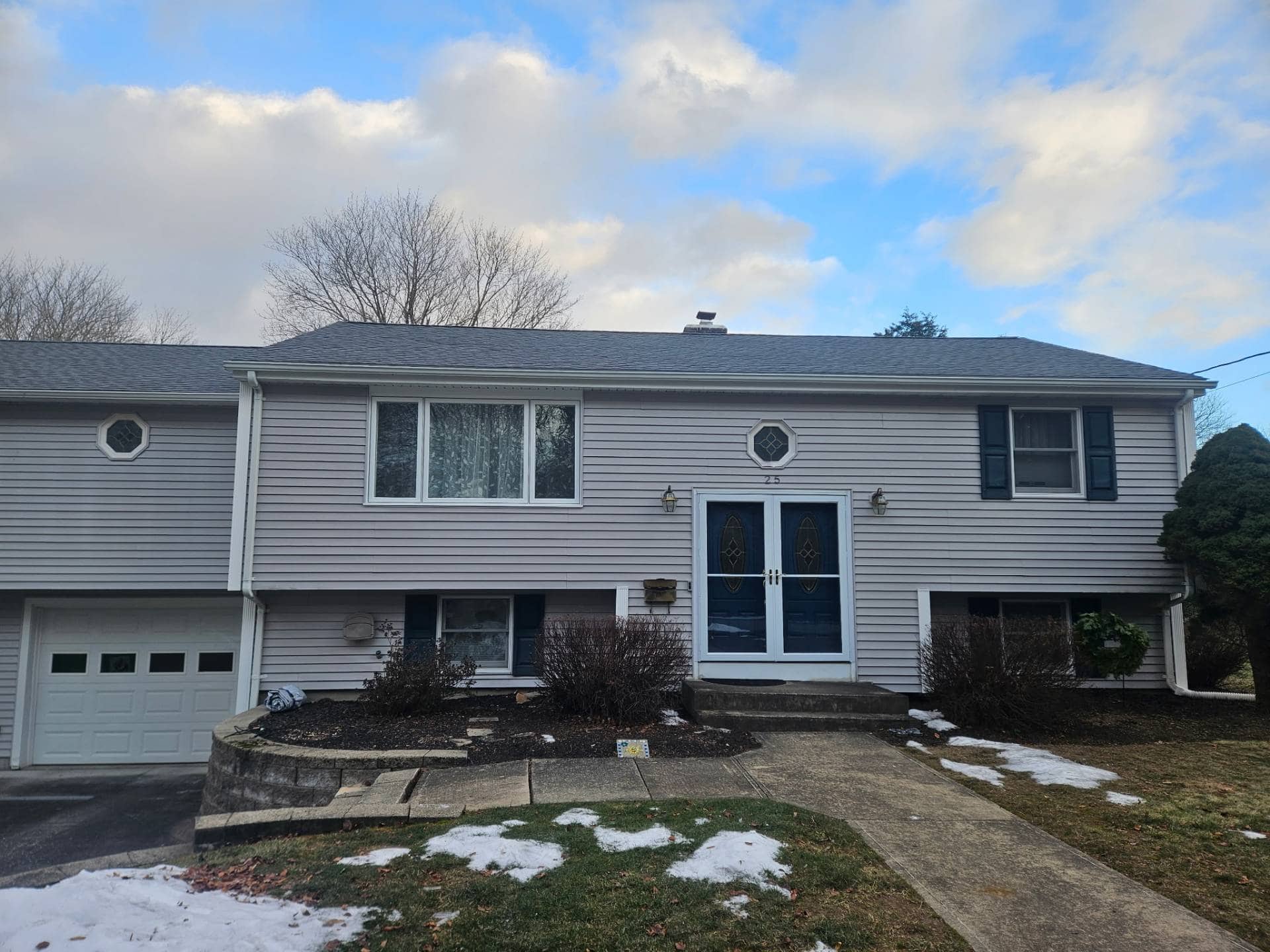 Completed roof replacement on a ranch home by AMP Roofing in Easton