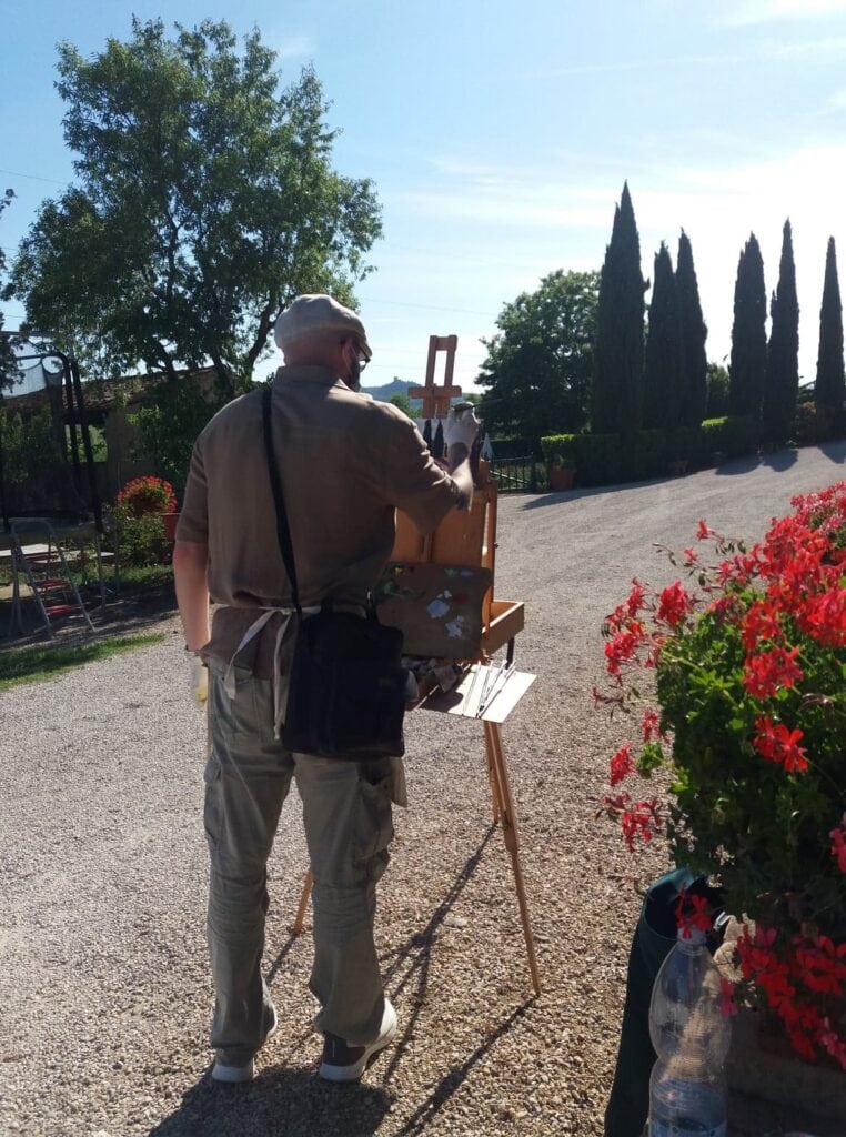 Andrea Bocedi painting Cypress Tree Alley en plein air at Castel Spedaletto near Pienza in Tuscany