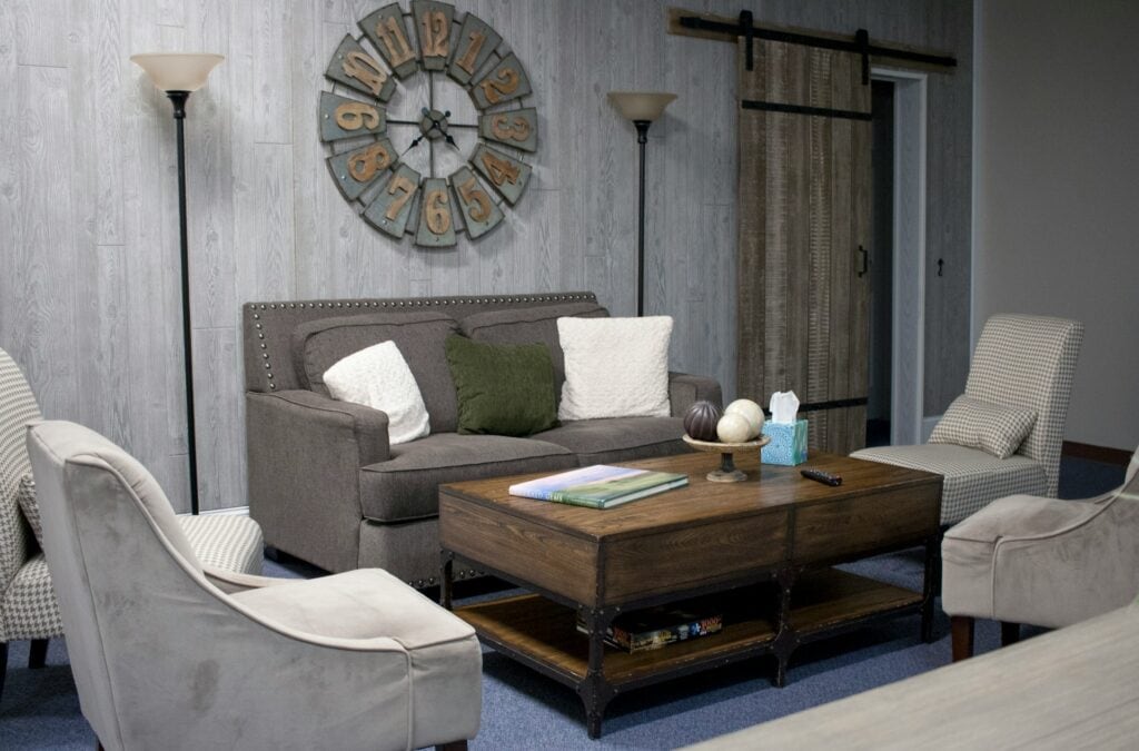 Room with comfortable couches single seats with a coffee table in the middle