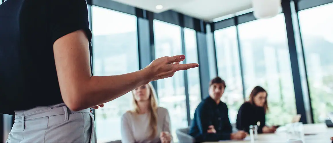 Person leading a meeting, engaging colleagues through BeOne Careers.