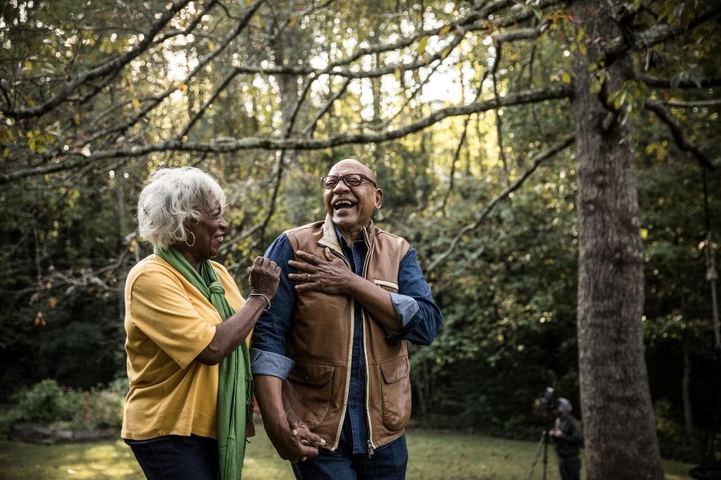 Happy senior couple walking outdoors in nature