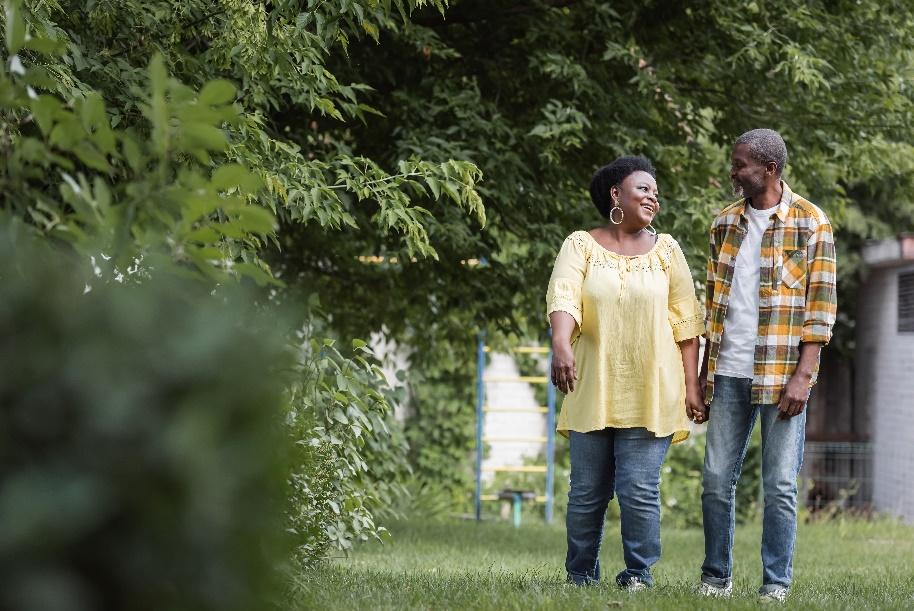 Couple walking outdoors surrounded by greenery