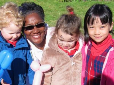A teacher and 3 toddlers smiling outside | Bishop Hamilton Montessori School in Ottawa