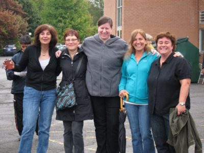 Staff smiling outside of Bishop Hamilton Montessori School in Ottawa