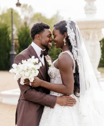 A beautiful wedding celebration showing Olympians Noah Lyles and Junelle Bromfield smiling together, representing the beautiful union of Jamaican and American cultures.