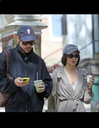 Candid street style photo of Zoe Kravitz and Harry Styles walking together.