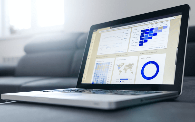 Notebook work with statistics on sofa business