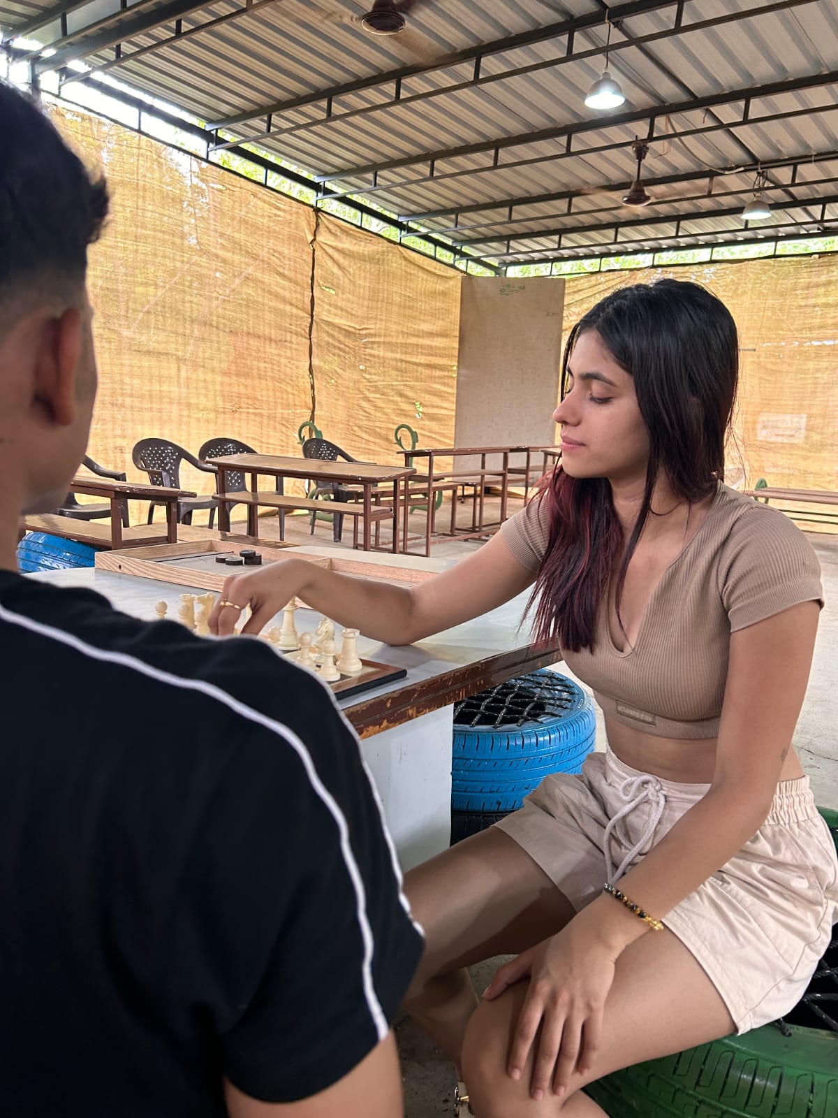 one girl and boy playing chess at camp unity