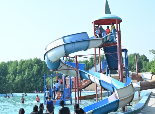 a group of people enjoying water slides at Camp United