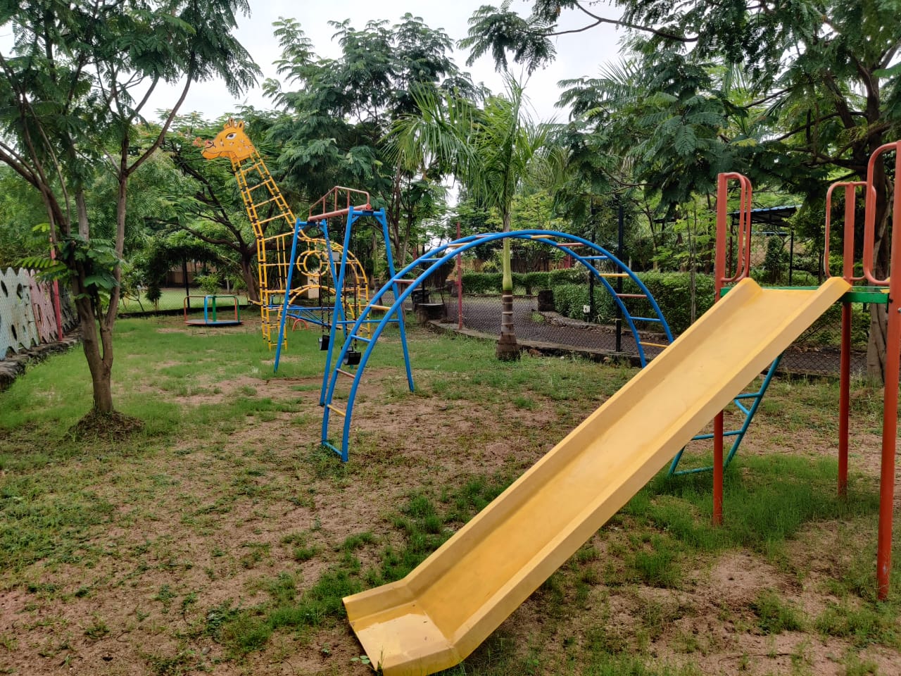 Various monkey bars and metal climbing structures painted in blue and yellow camp unity
