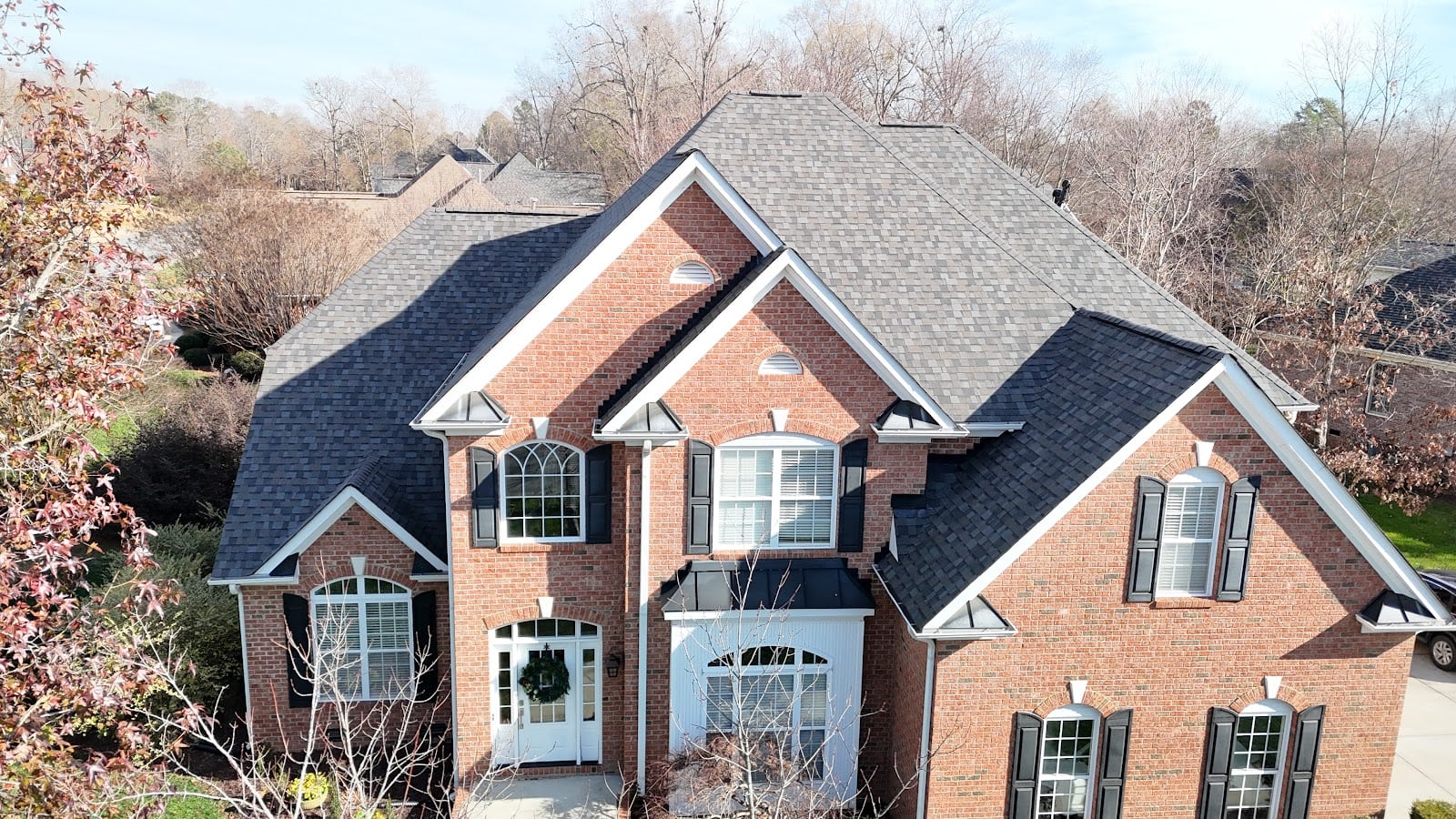 Brick home with multiple gables after a roof replacement in Charlotte, NC
