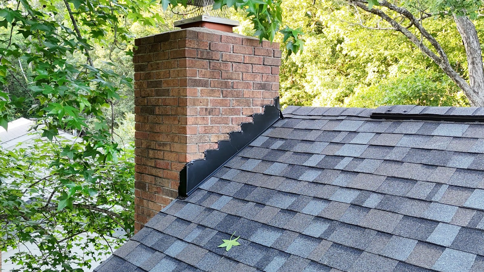 Brick chimney with new flashing and shingles
