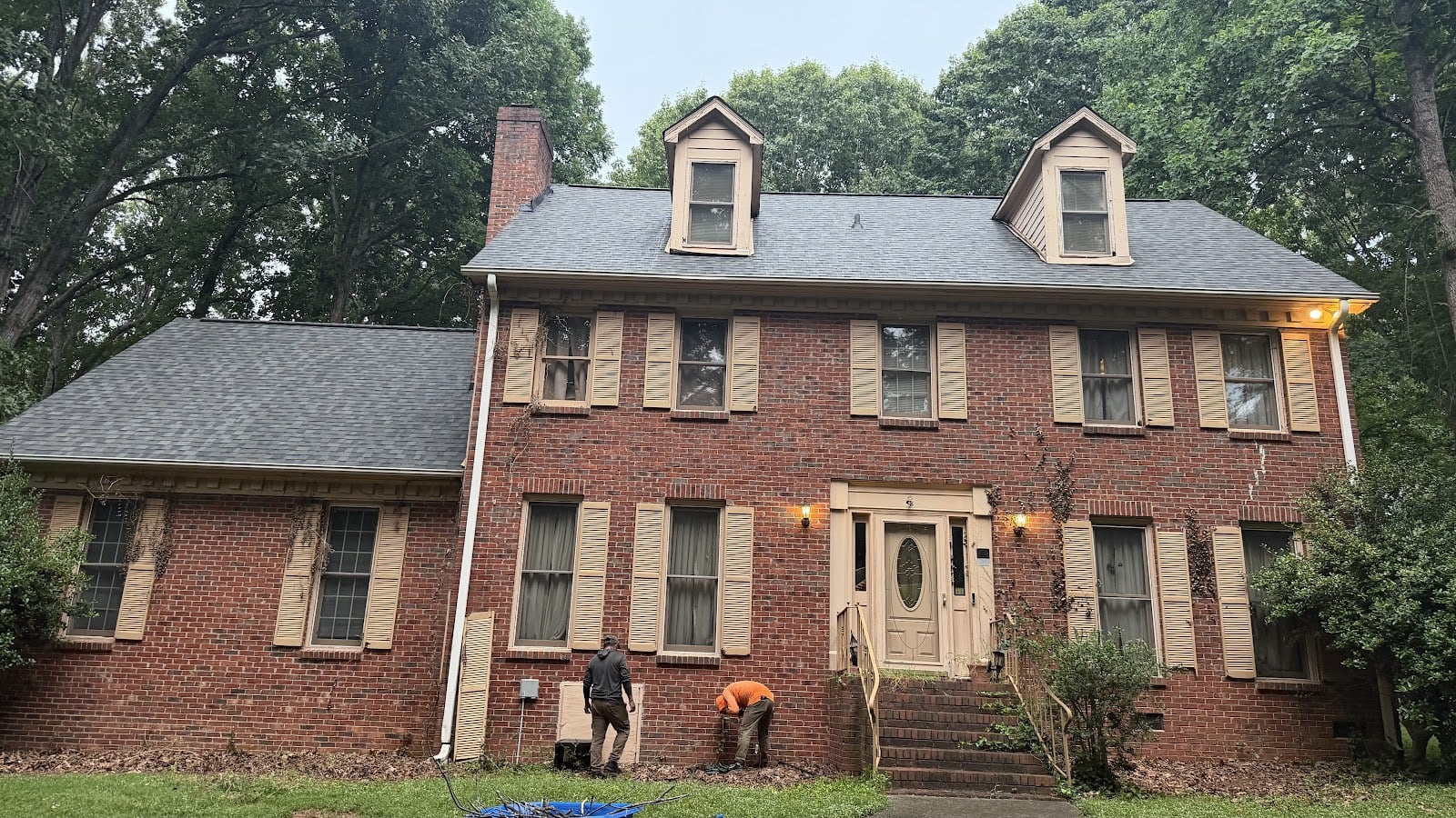 Brick colonial with three dormers after a roof replacement in Charlotte, NC