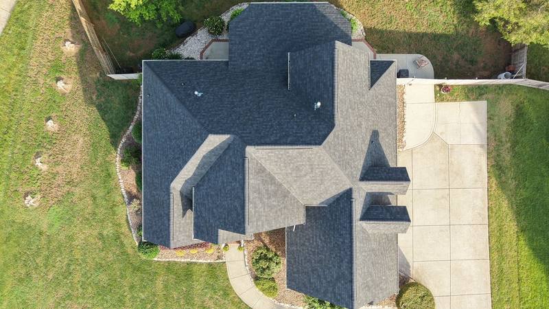 Overhead drone view of a finished charcoal shingle roof