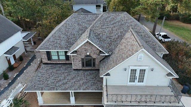 New shingle roof on a brick and siding home with a wraparound porch