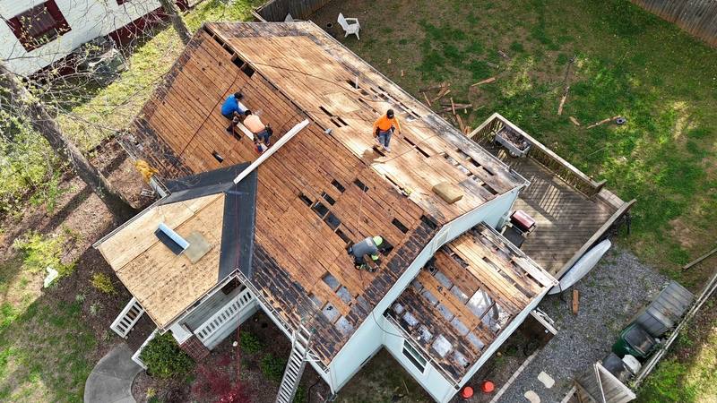 Charlotte Ace Roofing crew tearing off an old roof down to the decking