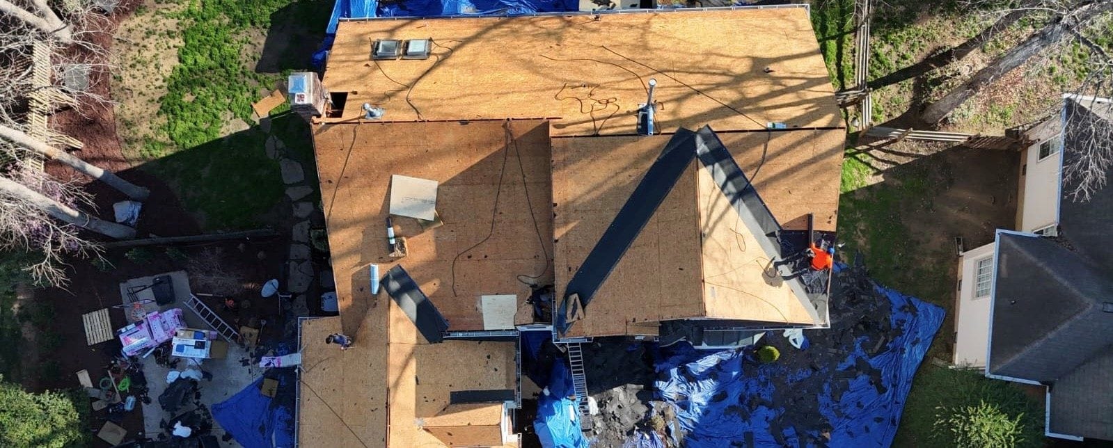 Drone view of new plywood roof decking during a Charlotte roof replacement