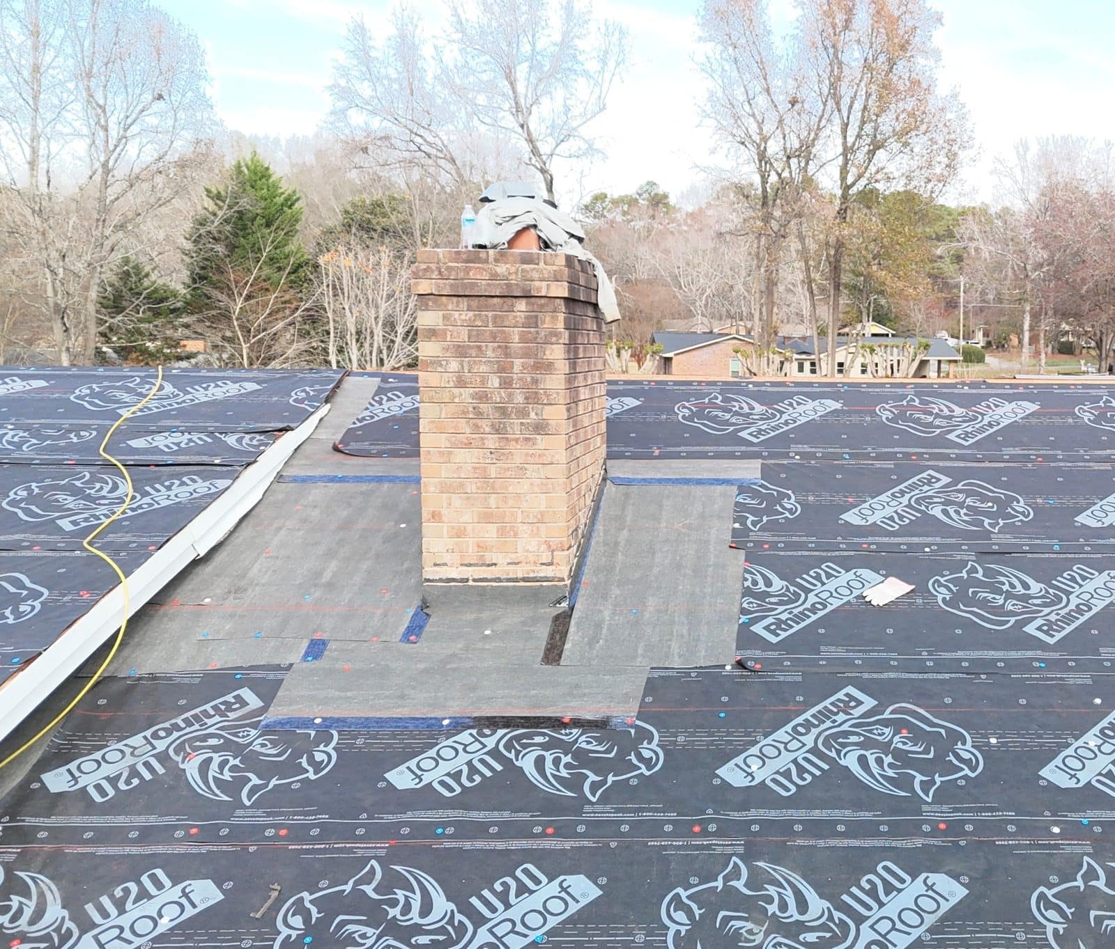 Ice and water shield installed around a chimney before new shingles in Charlotte, NC