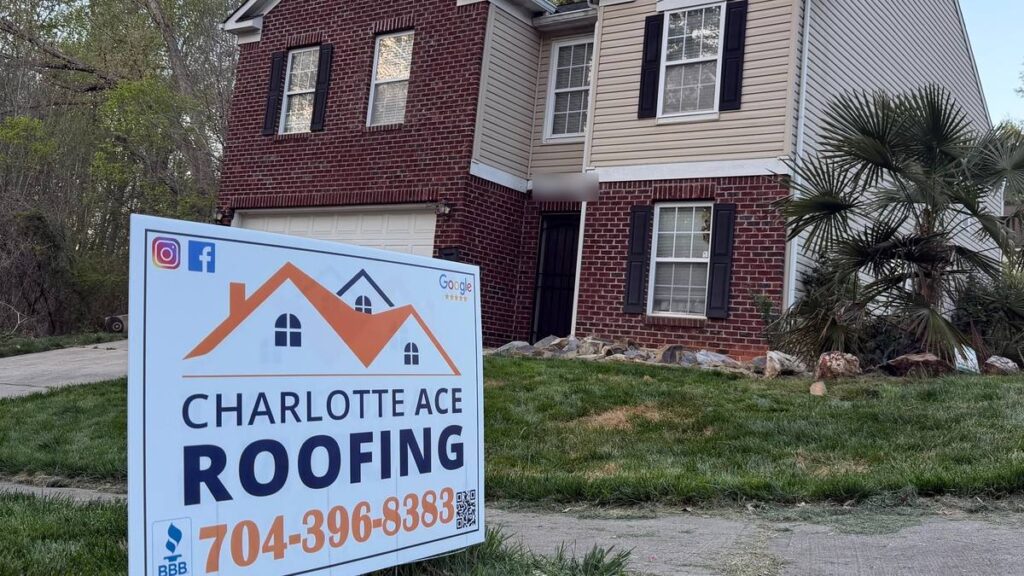 Two-story brick and siding home in Matthews, NC after a roof replacement by Charlotte Ace Roofing, with the Charlotte Ace Roofing yard sign out front