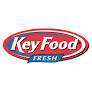 Key Food Fresh logo featuring the words Key Food in bold white letters on a red oval background, with the word Fresh in white on a blue ribbon beneath. The logo is outlined in blue and white.