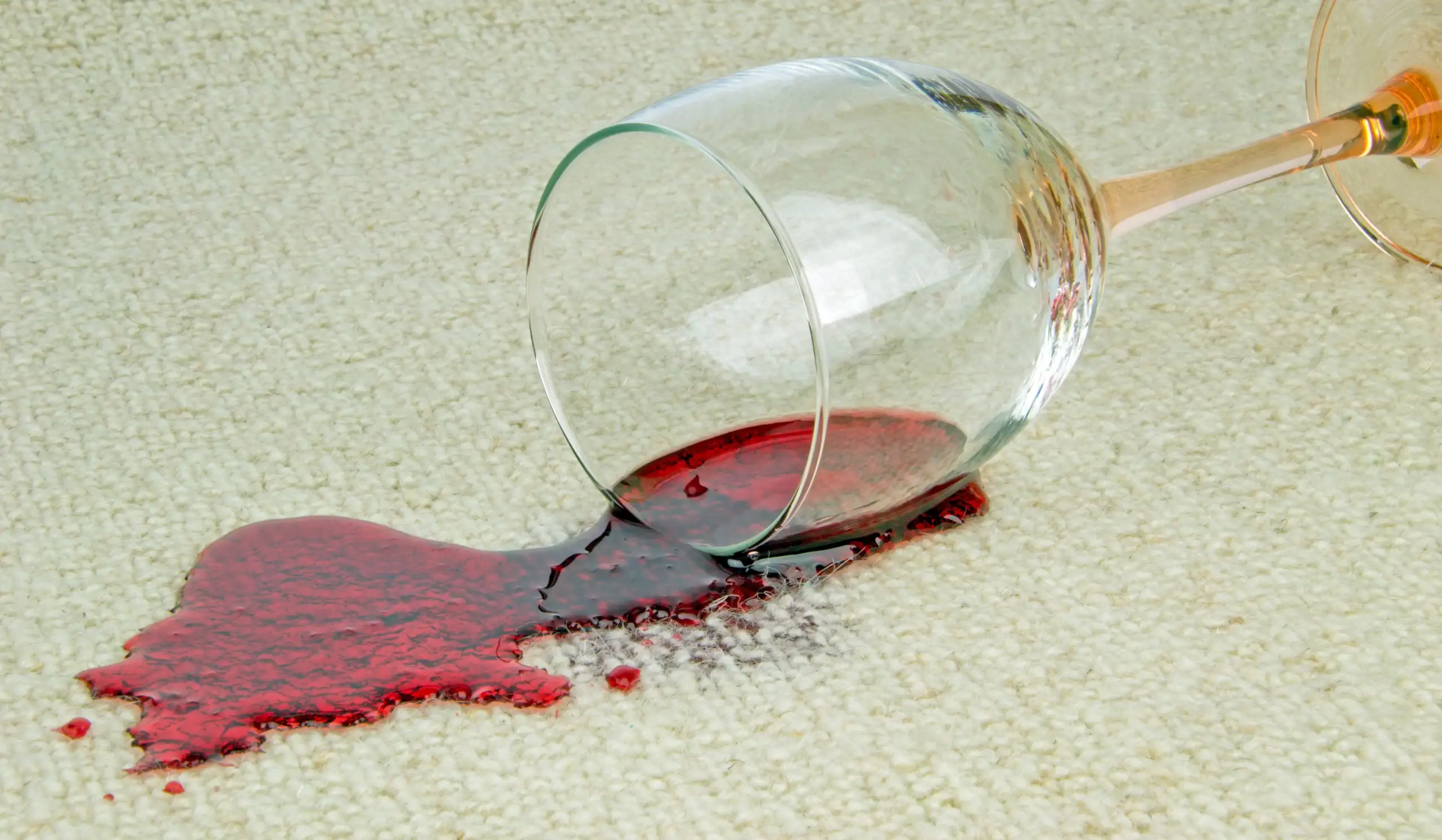 Red wine spilled on cream carpet before professional carpet cleaning in Saanich BC